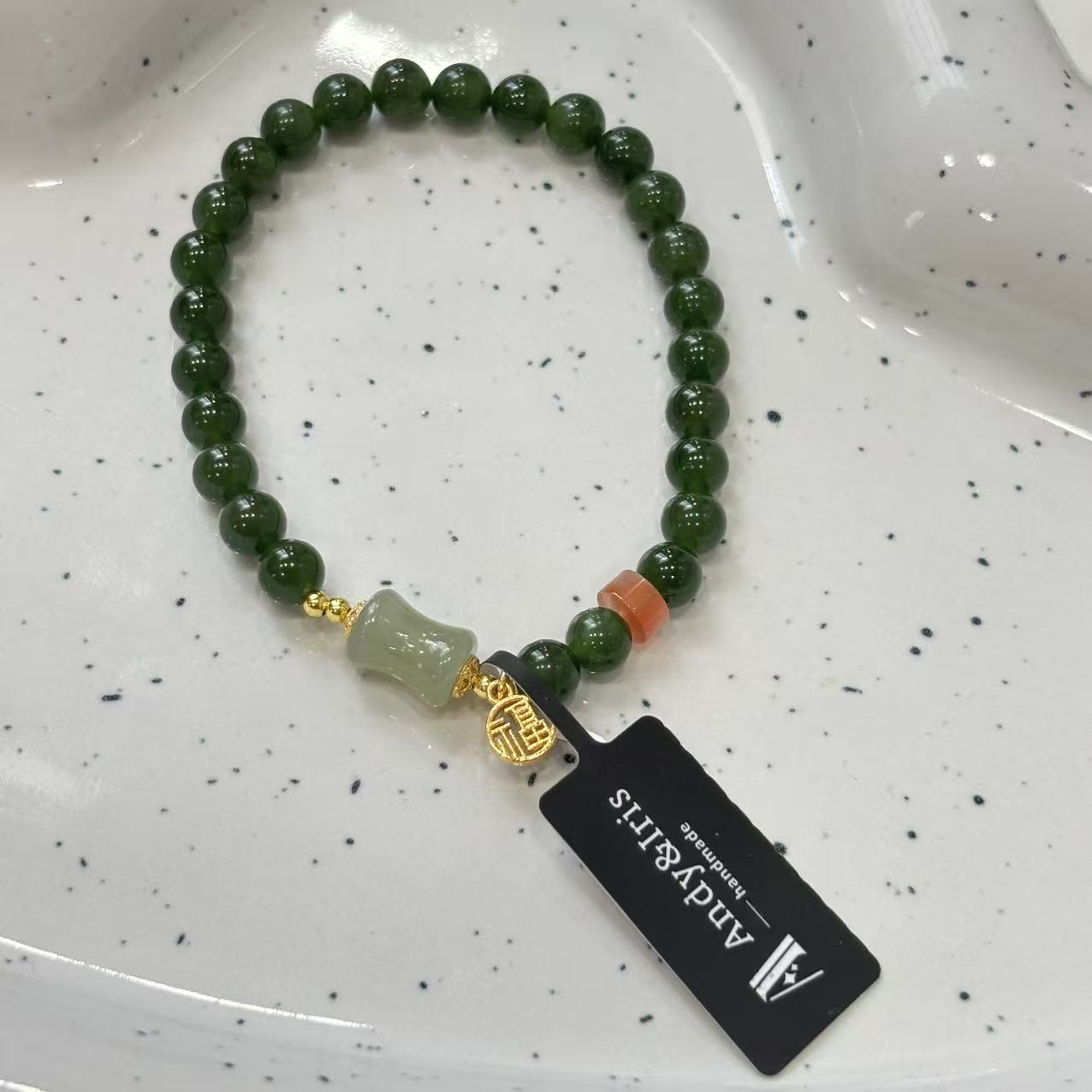 feature 6mm jade beads, accented with Nanhong agate, silver, and amber