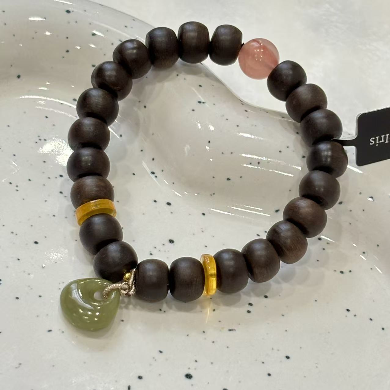 combines wood and Hetian jade, with amber and Nanhong agate accents